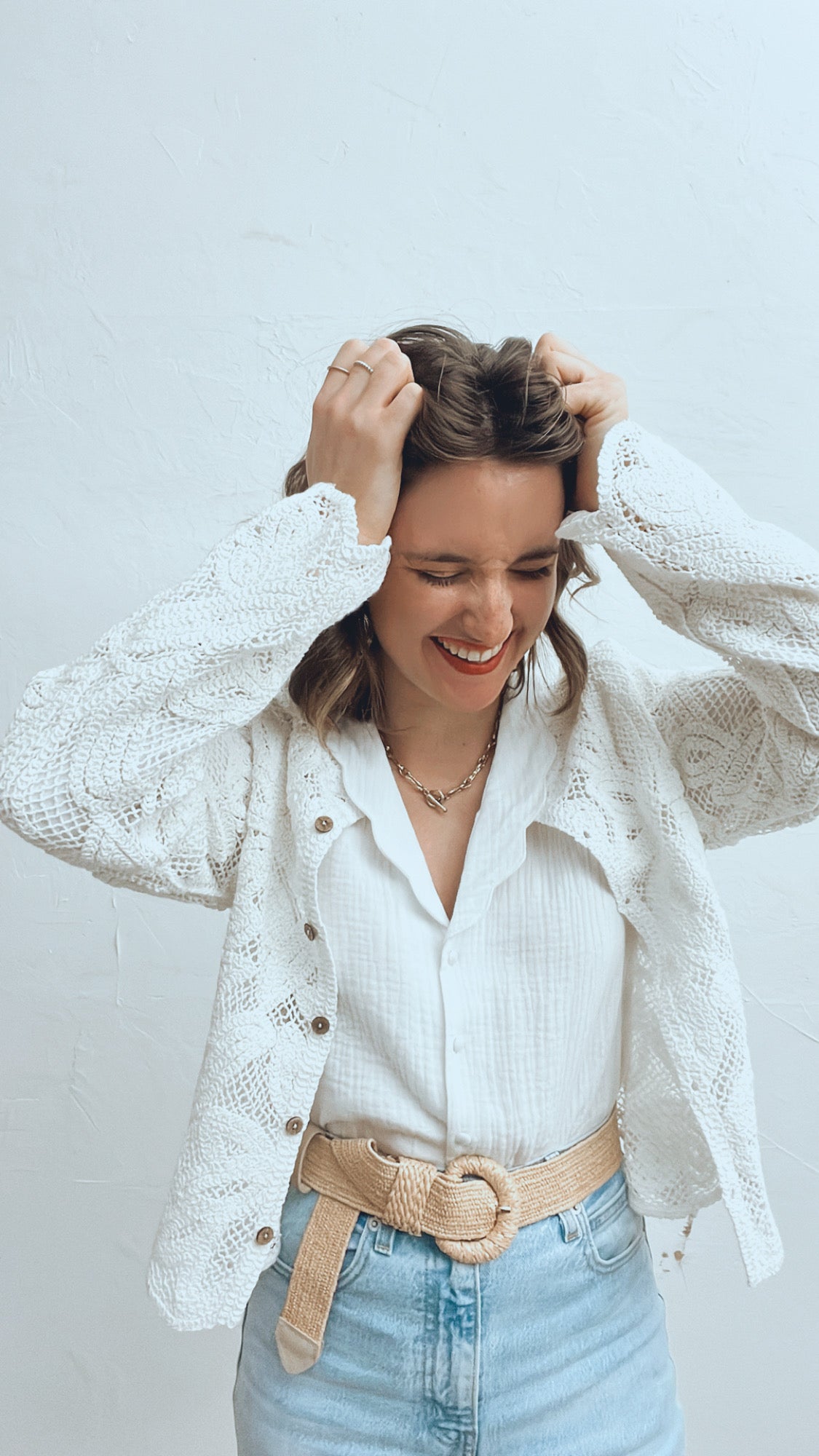 Maison Torrini Store, French store owner, Sydney based fashion stylist, smiling, wearing a gauze cottong scallops collar white blouse, white crochet cardigan, and a raffia belt